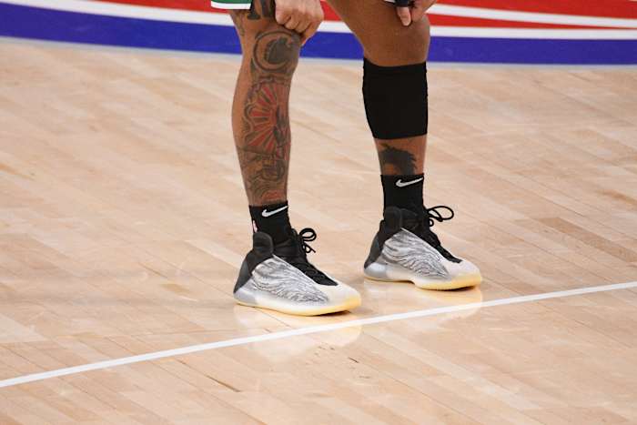 Grey and black Yeezy basketball shoes.